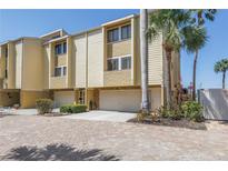 Spacious multi-level townhouse featuring a two-car garage and private entrance at 472 Sandy Hook Rd, Treasure Island, FL 33706