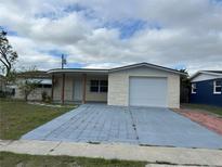 Charming single-story home with a covered porch and a one-car garage at 5151 Janice Ln, Holiday, FL 34690