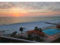 Beautiful beach view with a pool and palm trees, perfect for relaxation at sunset at 880 Mandalay Ave # S511, Clearwater Beach, FL 33767
