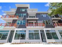 Modern multi-story building featuring orange balcony railings and large retail windows at 11 29Th N St, St Petersburg, FL 33713