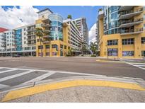 Street view of the condo buildings with storefronts and crosswalk in downtown St. Petersburg, Florida at 1120 E Kennedy Blvd # 615, Tampa, FL 33602