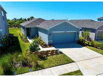 Charming single-story home with a well-manicured lawn and a two-car garage, showcasing its inviting curb appeal at 11268 Fieldstone Dr, Palmetto, FL 34221