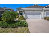 Charming townhome featuring an attached two-car garage and manicured landscaping at 13539 Circa Crossing Dr, Lithia, FL 33547
