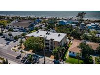 Beautiful condo building near the beach with palm trees and serene surroundings at 1700 Pass A Grille Way # 9, St Pete Beach, FL 33706