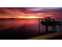 Beautiful waterfront view with gorgeous sunset and boat lift at 2172 Harbor View Dr, Dunedin, FL 34698