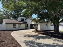 Charming single-Gathering home with a long driveway and well-maintained landscaping around mature shade trees at 3924 Orchard Hill Cir, Palm Harbor, FL 34684