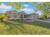 Charming single-story home with manicured lawn and tasteful landscaping, showcasing curb appeal at 4010 Lithia Ridge Blvd, Valrico, FL 33596