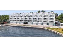 Stunning waterfront condo building with multiple balconies and covered parking spaces for residents at 4950 Bayshore Blvd # 27, Tampa, FL 33611