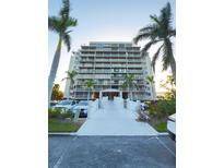 A full exterior view of the condo building and entrance, flanked by palm trees on each side at 500 N Osceola Ave # 808, Clearwater, FL 33755