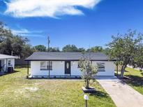 Charming single-story home with a well-maintained lawn, lovely landscaping and a paved driveway at 5290 101St Ave, Pinellas Park, FL 33782