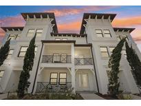 Beautiful white townhouse with balconies, modern architecture, and perfectly manicured landscaping at 5351 Bridge St # 15, Tampa, FL 33611