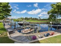 View of private boat dock with multiple boats, including lounge chairs for enjoying waterfront living at 6533 Channelside Dr, New Port Richey, FL 34652