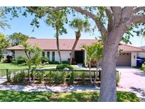 Front exterior of home with well-manicured landscaping and a tile roof at 773 Snug Is, Clearwater Beach, FL 33767