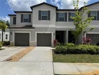 Charming townhouse featuring a one car garage and nicely manicured landscaping at 11823 Dumaine Valley Rd, Riverview, FL 33579