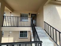 Exterior of the building showing the entrance, stairs and railing at 1370 Heather Ridge Blvd # 310, Dunedin, FL 34698