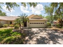 Charming single-story home featuring a two-car garage, well-kept lawn, and mature landscaping at 1616 Laughton Pl, Sun City Center, FL 33573