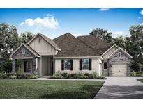 Charming single-story home featuring stone accents, a gabled roof, and a two-car garage at 17444 Nokota Ave, Hudson, FL 34667