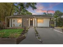 Charming home featuring a modern design with a covered porch and well-manicured front yard at 3027 Burlington N Ave, St Petersburg, FL 33713