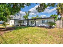 Charming single-story home boasts a beautifully landscaped front yard and freshly painted exterior at 321 Shore E Dr, Oldsmar, FL 34677