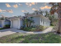 Charming single-story home with a well-manicured lawn, attached garage, and lovely landscaping at 5104 2Nd E Ave, Palmetto, FL 34221