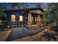 Charming home featuring a brick path leading to a cozy porch with brick pillars at 525 Lexington St, Dunedin, FL 34698