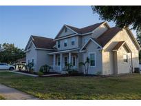 Beautiful two-story home showcases a covered front porch, mature landscaping, and an inviting facade, ensuring curb appeal at 601 Gay Rd, Seffner, FL 33584