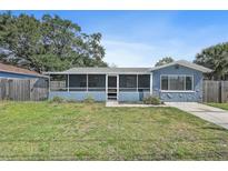 Charming single Gathering home with a screened in front porch and a well-maintained lawn at 6481 64Th N Ave, Pinellas Park, FL 33781