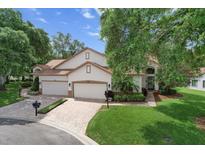 Charming home featuring a well-manicured lawn, two car garage, and welcoming entrance at 8040 Summerbreeze Ter, Spring Hill, FL 34606