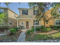 Charming two-story home featuring a welcoming front porch and well-maintained landscaping at 9205 English Oaks Ln, Riverview, FL 33578