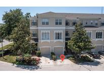 Beautiful three-story townhome featuring an attached two-car garage and well-manicured landscaping at 1105 Venetian Harbor Ne Dr, St Petersburg, FL 33702