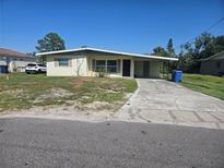 Charming single-story home with a covered carport and a well-maintained front yard at 125 18Th Nw St, Ruskin, FL 33570