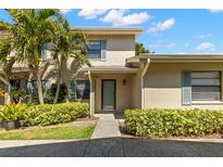 Inviting townhouse featuring a well-manicured lawn and lush tropical landscaping for enhanced curb appeal at 2131 Ridge S Rd # 130, Largo, FL 33778
