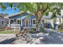 Charming bungalow-style home with blue siding, a red front door, and a covered carport at 2920 N 11Th St, Tampa, FL 33605