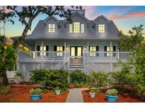 Charming home featuring a welcoming front porch, well-maintained landscaping, and a light-colored exterior at 380 Wellington Ave, Oldsmar, FL 34677