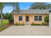 Charming home with lush landscaping, bright exterior, and inviting front entrance at 3827 Trophy Blvd # 0, New Port Richey, FL 34655