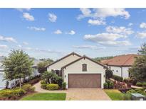 Charming single-story home with a brick driveway, well-maintained landscaping, and a two-car garage at 4257 Rosatti Rd, Wesley Chapel, FL 33543