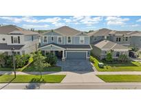 Charming two-story home features a well-manicured lawn, driveway, and a covered front porch at 4583 Emprise Way, Land O Lakes, FL 34638