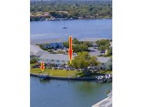 Aerial view showcasing waterfront condos with boat docks and serene water views at 5242 Beach Se Dr, St Petersburg, FL 33705