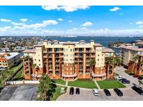 Beautiful condo building overlooking the water featuring balconies and palm trees at 5301 Gulf Blvd # B508, St Pete Beach, FL 33706