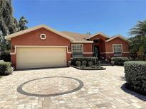 Charming single-story home featuring a circular paved driveway and lush landscaping at 5920 30Th S Ct, St Petersburg, FL 33712