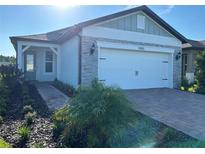 Charming single Gathering home featuring a two car garage and manicured landscaping at 5981 Shorebird Br, Land O Lakes, FL 34638