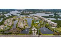 Beautiful aerial view of the Seminole Isle community featuring lakes, ponds, lush greenery, and well-maintained buildings at 7040 Key Haven Rd # 601, Seminole, FL 33777
