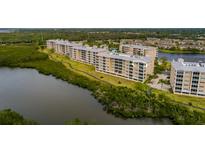 Exterior of the building in the Seminole Isle community, showcasing its proximity to the water and green spaces at 7040 Key Haven Rd # 601, Seminole, FL 33777