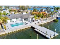 Waterfront home with modern pool, dock, and outdoor seating overlooking beautiful bay waters at 1493 Sea Gull S Dr, St Petersburg, FL 33707