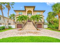 Stunning two-story home with lush landscaping, grand staircase entry, and twin garages at 2149 Bayou Grande Ne Blvd, St Petersburg, FL 33703
