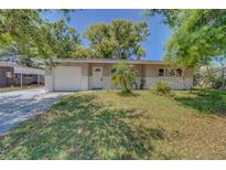 Charming single-story home with a well-maintained lawn, brick accents, and a one-car garage at 1710 S Lake Ave, Clearwater, FL 33756
