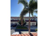 Well-maintained townhomes with garages and lush landscaping, creating a welcoming neighborhood ambiance at 2700 Bayshore Blvd # 519, Dunedin, FL 34698