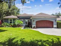 Charming single-story home features a well-manicured lawn and beautiful landscaping at 5416 Twin Creeks Dr, Valrico, FL 33596