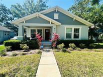 Charming bungalow with a well-maintained lawn and front porch, featuring a vibrant garden and secure ADT system at 724 15Th S Ave, St Petersburg, FL 33701