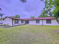 Charming one-story home with a well-manicured lawn and mature trees at 7609 Barry Rd, Tampa, FL 33615